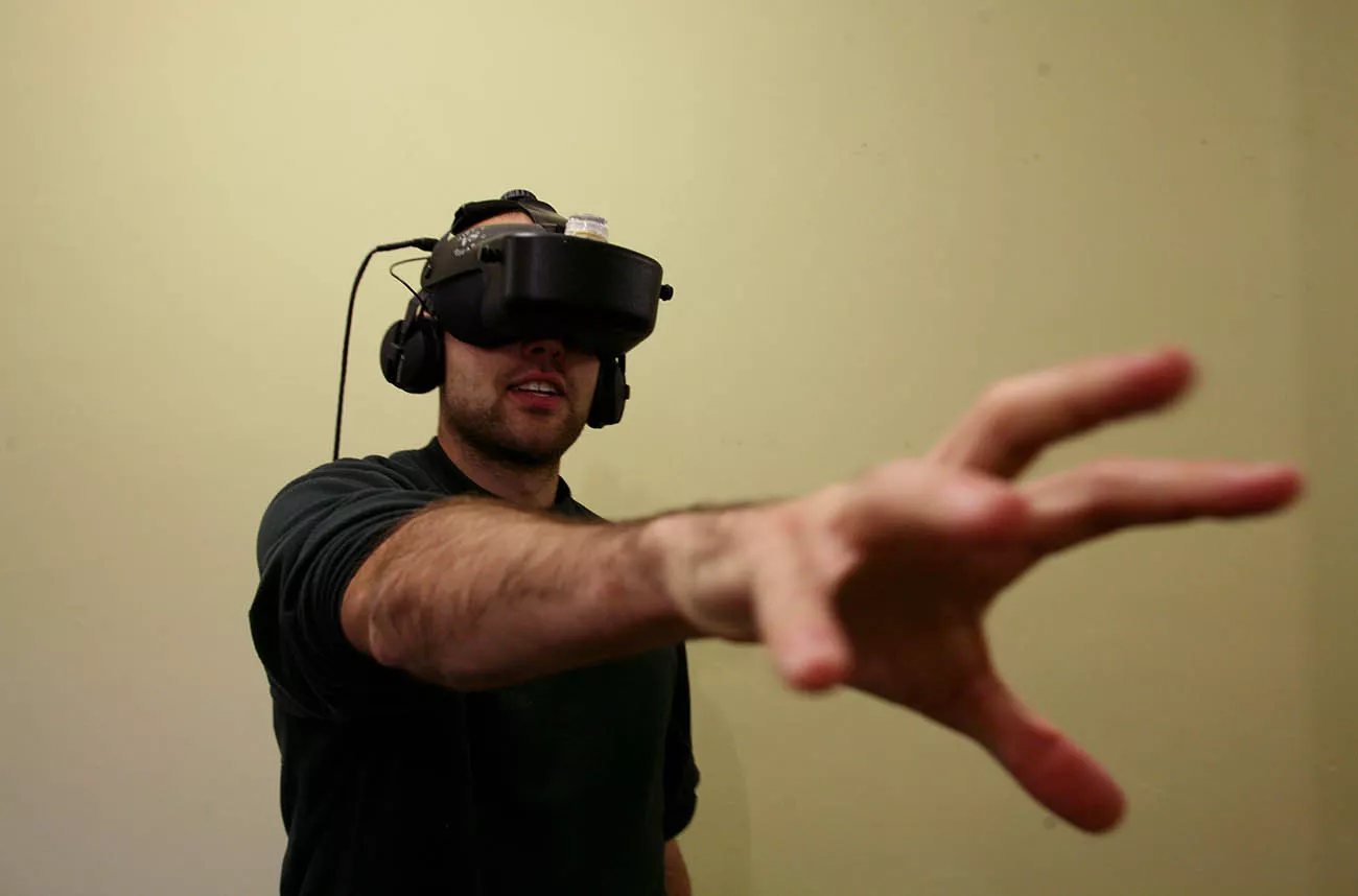 student in VR helmet