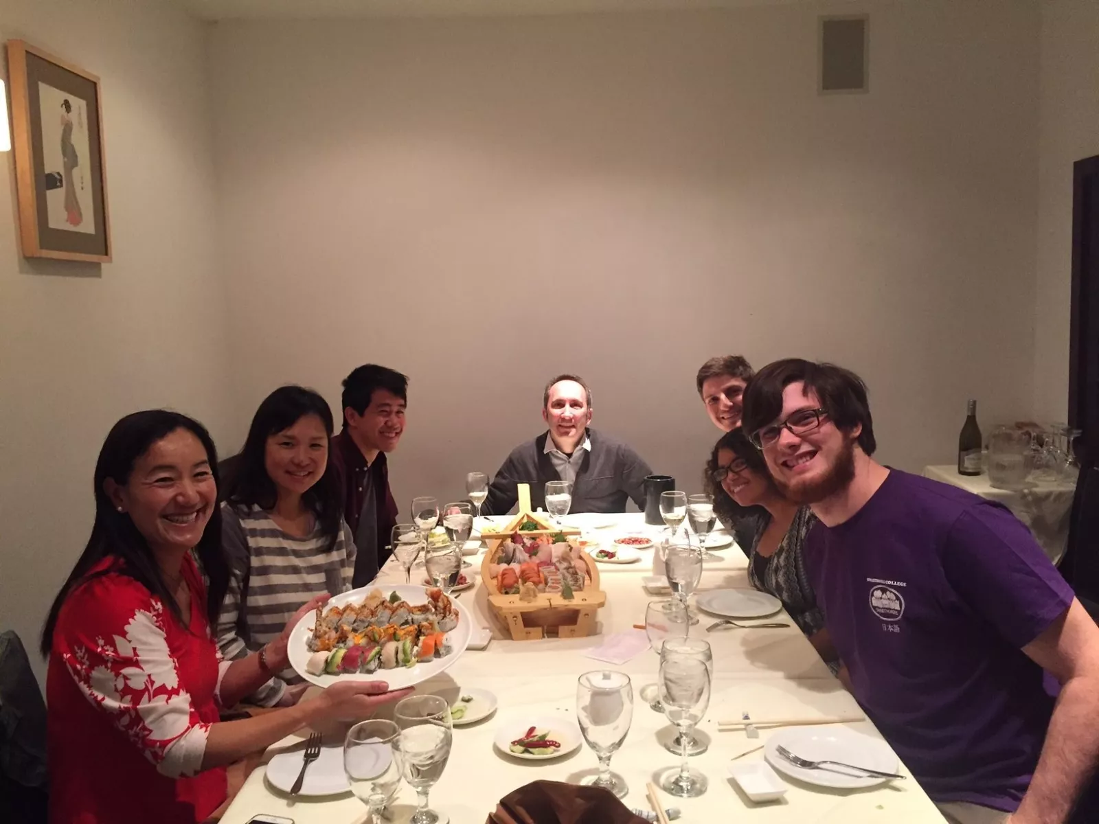 2017 graduating students and professors sitting at a dinner table. 