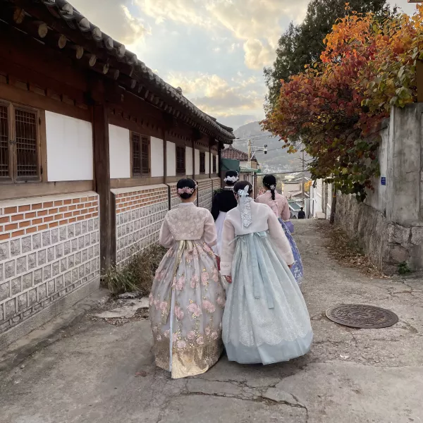 students in traditional dress walking on the street
